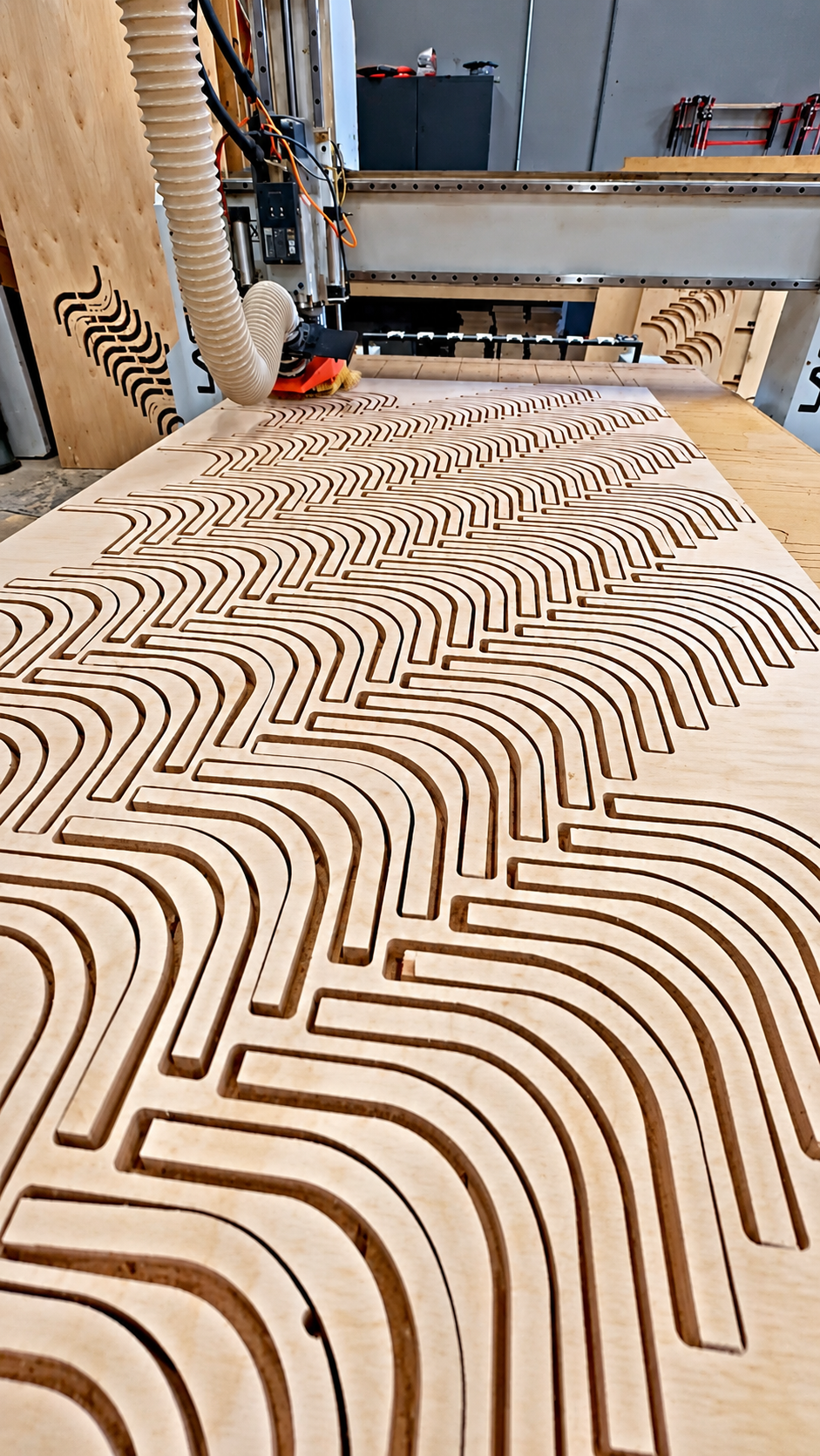 CNC milling machine carving a routed pattern into wood at T&S Building Solutions